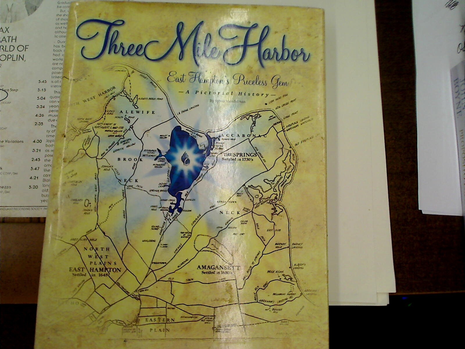 (SIGNED & INSCRIBED Sylvia Mendelmen) THREE MILE HARBOR – EAST HAMPTON’S…..